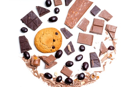 chocolate bar, shavings and cookies on a tableの写真素材