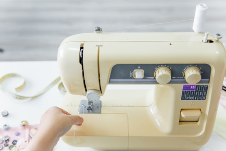 female hands are using a sewing machineの写真素材