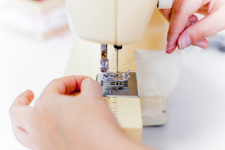 female hands are using a sewing machineの写真素材