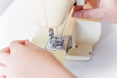 female hands are using a sewing machineの写真素材