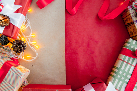 Female hands wrapping red christmas gift boxesの写真素材