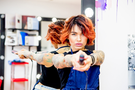Professional hairdresser working with client in salonの写真素材