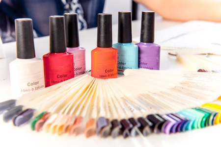 various colorful nail varnish in containers on a tableの写真素材