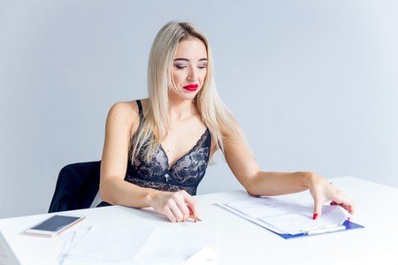 a businesswoman or a secretary in a jacket and lingerieの写真素材