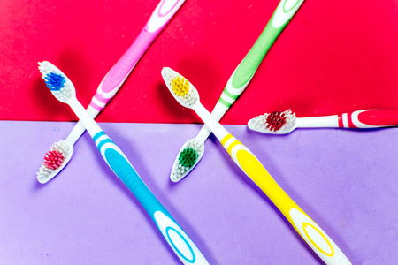 toothbrushes and a toothpaste on a colorful backgroundの写真素材