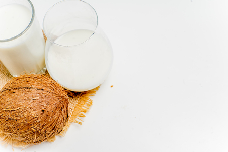 a glass of milk with bread and grainsの写真素材