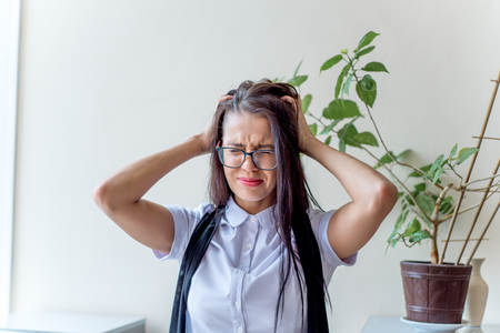 a depressed businesswoman under stress at workの写真素材