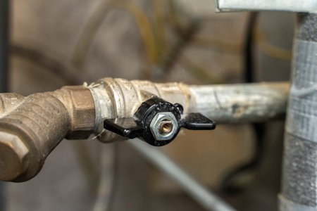 plumbing cabinet. turn off hot or cold water. Closeup of a water shutoff tap. rough water filter
