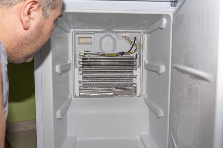 the master removed the refrigerator freezer fan for repair, the cooling radiator general plan, the ice below, decides how to repairの写真素材