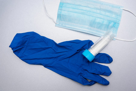 disposable medical mask, disposable blue glove, test tube