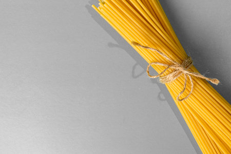 spaghetti on a grey background, tied with a rope,Â copy spaceの写真素材
