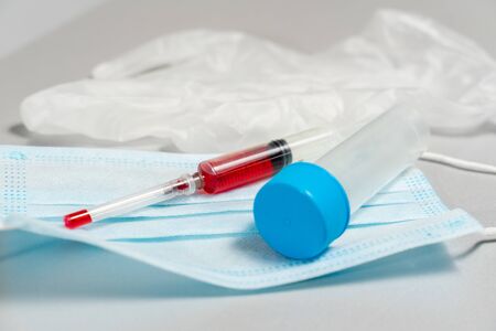 test tube, disposable glove, syringe with blood test, disposable mask. Blood Test Kitの写真素材