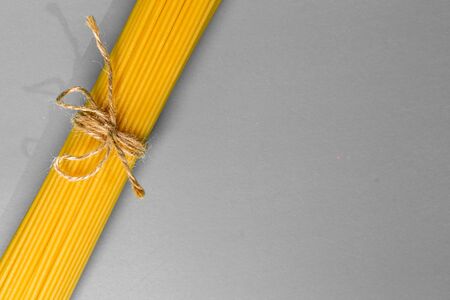 spaghetti on a grey  background, tied with a rope,
Â copy spaceの写真素材