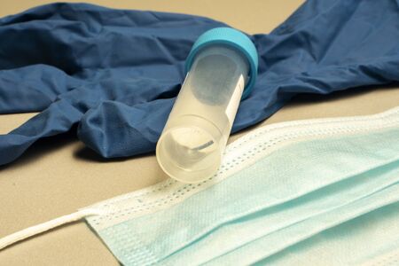 disposable medical mask, disposable blue glove, test tube for analysis. Treatment and prevention of Chinese coronavirus in a hospitalの写真素材