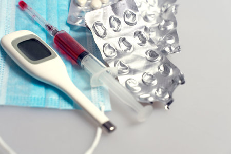 syringe with red liquid, disposable mask, tablets in a blister, empty blisters for tablets,...