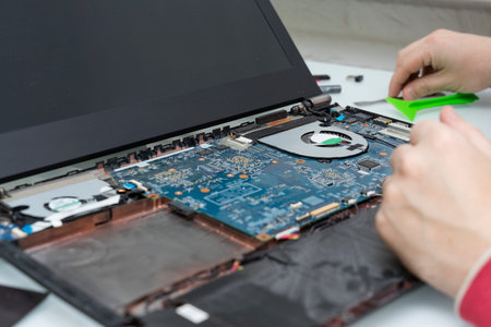 laptop repair. disassembled laptop and wizard's hand