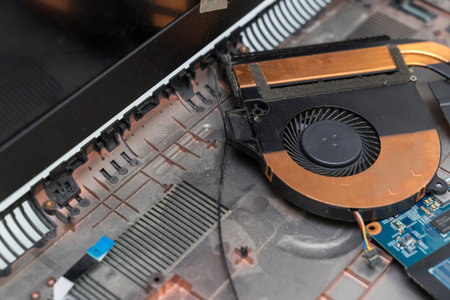disassembled dusty laptop. cooler close-up