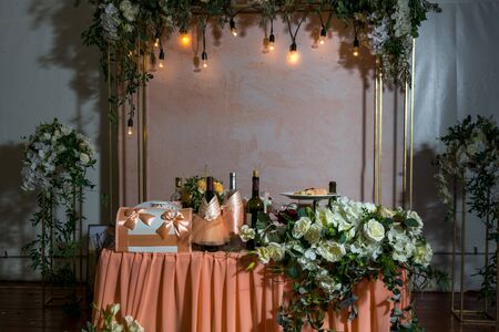 beautifully decorated table of the bride and groom in peach colors. wedding decorations. twilightの写真素材