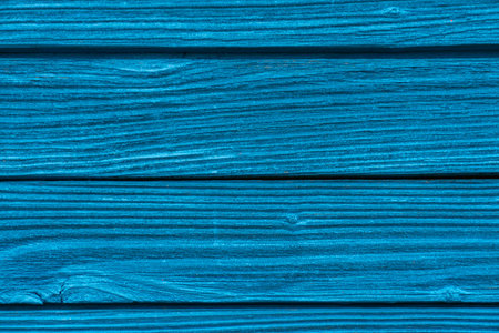 old boards painted with blue paint. blue background