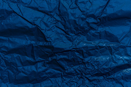 crumpled blue paper. abstract background. dark blue backgroundの写真素材