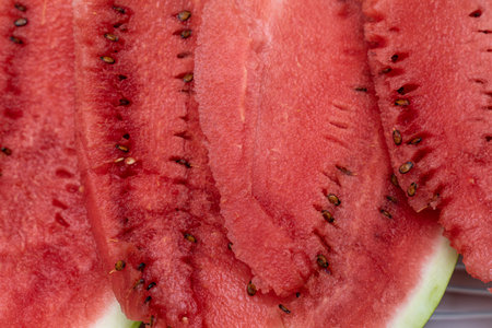 closeup slices of watermelon with pits. juicy and ripe watermelon