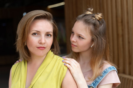 portrait of a beautiful red-haired woman with freckles and her teenage daughter