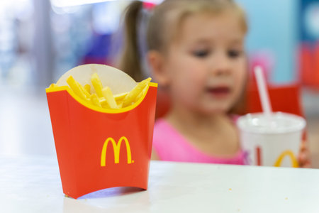 07 19 2020 Russia, Moscow.little girl at mcdonald's French fries