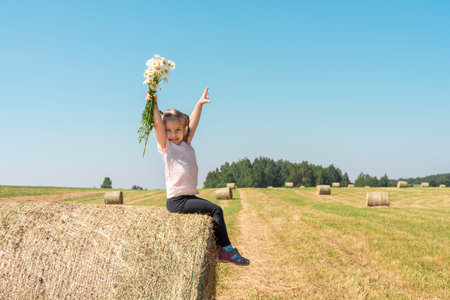 little girl picking strawberries in the gardenの写真素材