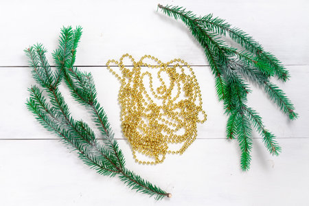 christmas background. Christmas garland and spruce branches on a light background