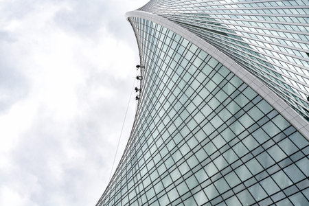 high-rise workers wash windows in a skyscraper.futuristic backgroundのeditorial素材