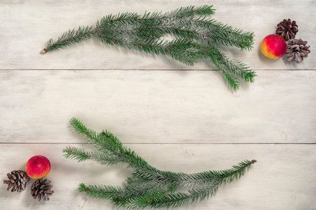 winter layout. wooden white background and composition of pine cones, fruits and branches