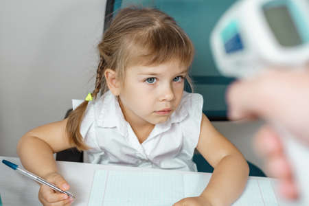 temperature is measured for a child at schoolの写真素材