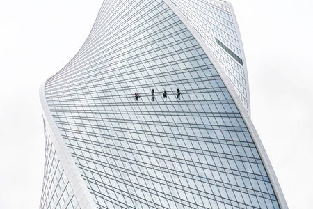 08 19 2020 Moscow, Russia. washers of windows on the walls of skyscrapers Moscow City