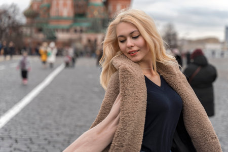 01 14 2020 Moscow, Russian Federation. beautiful young girl in an artificial coat posing in the...