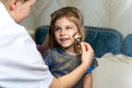 makeup process of a little cute girl.の写真素材