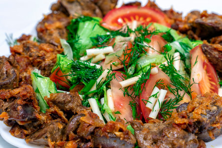 warm salad of vegetables and cheese chechil with chicken liver close-upの写真素材