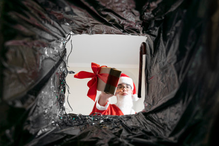 santa throws gifts in the trash. view from the trash bag. end of Christmas holidays. spoiled christmas.の写真素材