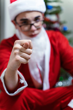 santa claus shows fig. focus on the hand. spoiled christmas. cancellation of New Year's holidays. Christmas in quarantine due to coronavirusの写真素材