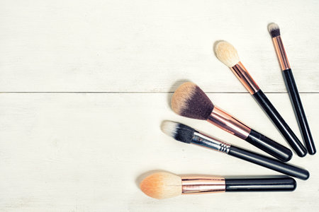 makeup brush set flat lay with copy space