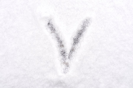 a check mark is drawn on white fluffy snow.の写真素材