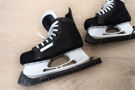 black mens ice hockey skates on wooden background
