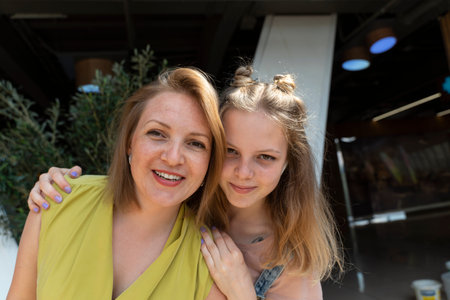 cute teenage daughter hugs mother and happy, family and relationships concept