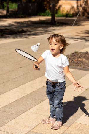 emotional little caucasian girl 3-4 years old playing bambinton on a summer dayの写真素材