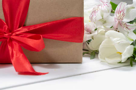 composition of a gift box, and a bouquet of flowers. holiday and congratulations conceptの写真素材