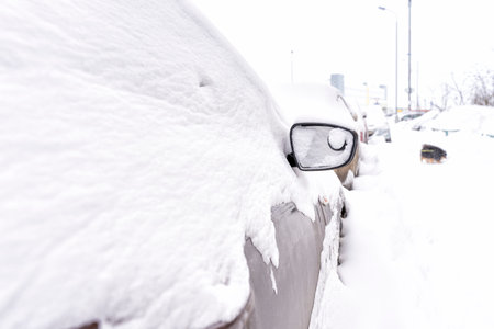 residential area courtyard after a cyclone and heavy snowfall. the cars are covered with snow. small...