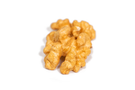 Single walnut kernel isolated on white background. Top view.