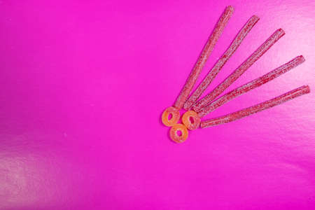 Flat lay composition with different yummy candies and space for text on color backgroundの写真素材