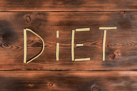 Unhealthy diet. text diet of jelly marmalade strips on wooden background