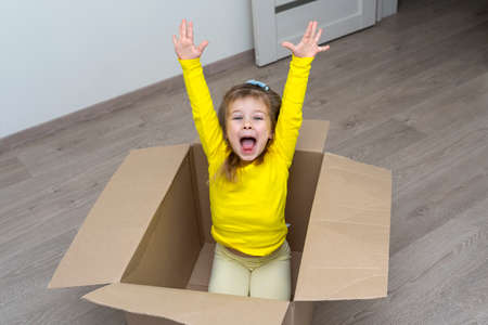 moving to a new apartment. baby in a cardboard boxの写真素材