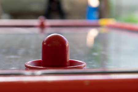 Red stick on an air hockey table. Entertainment and leisureの写真素材